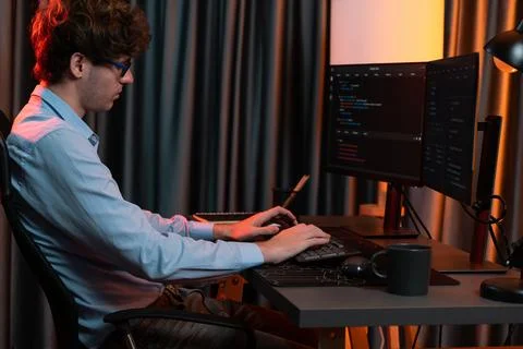 Working IT developer concentrating online software at neon light room. Gusher. 스톡 사진