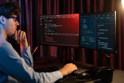 Working IT developer concentrating online software at neon light room. Gusher. 스톡 사진