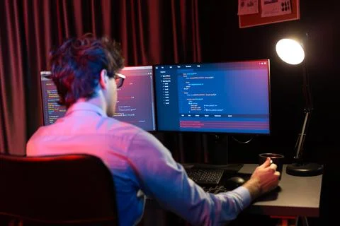 Working IT developer concentrating online software at neon light room. Gusher. 스톡 사진
