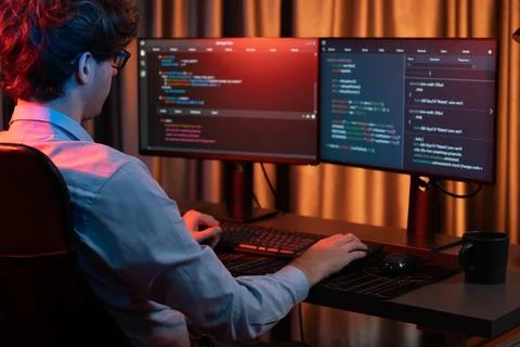 Working IT developer concentrating online software at neon light room. Gusher. Foto stock