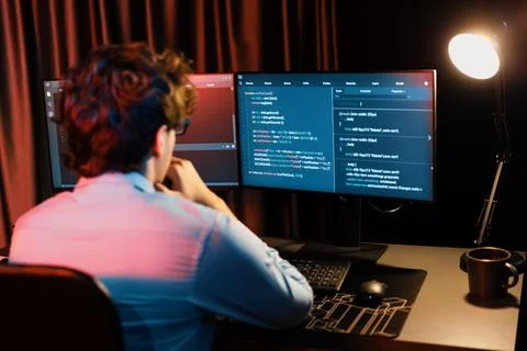 Working IT developer concentrating online software at neon light room. Gusher. Foto stock