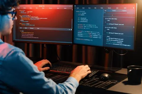 Working IT developer concentrating online software at neon light room. Gusher. 스톡 사진