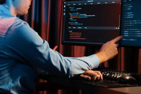 Working IT developer concentrating online software at neon light room. Gusher. Foto stock