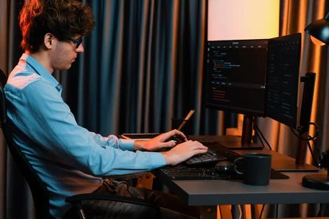 Working IT developer concentrating online software at neon light room. Gusher. 스톡 사진