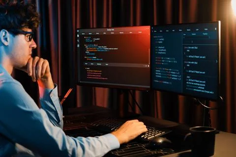 Working IT developer concentrating online software at neon light room. Gusher. 스톡 사진