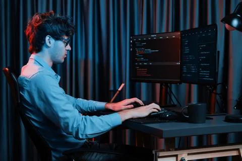 Working IT developer concentrating online software at neon light room. Gusher. 库存照片