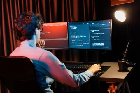 Working IT developer concentrating online software at neon light room. Gusher. 库存照片