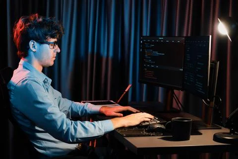 Working IT developer concentrating online software at neon light room. Gusher. 스톡 사진