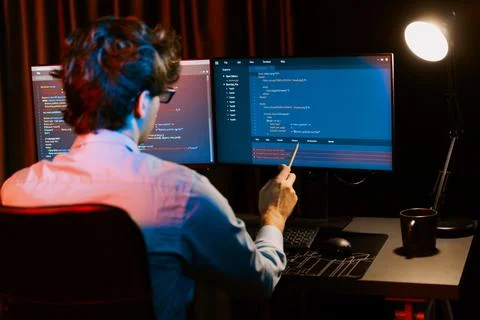 Working IT developer concentrating online software at neon light room. Gusher. Foto stock