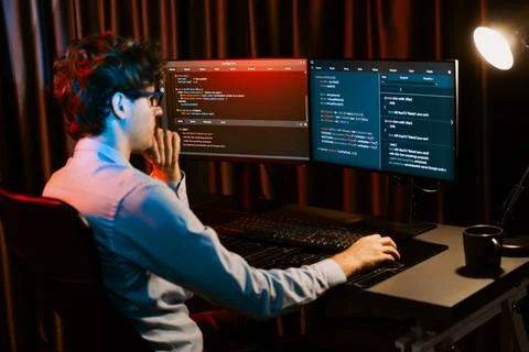 Working IT developer concentrating online software at neon light room. Gusher. Foto stock