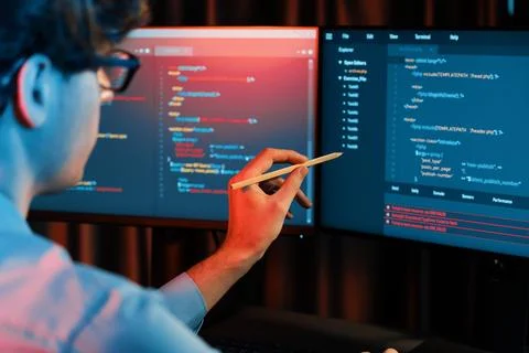 Working IT developer pointing with pencil on online software coding. Gusher. Foto stock