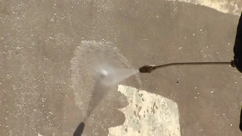 Working jet of water under pressure washes old plaster from the wall Stock Footage 105684738