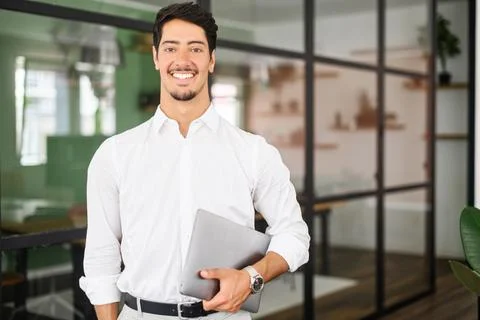 Working with joy. Smiling cheerful hispanic business man wearing formal white Stock Photos