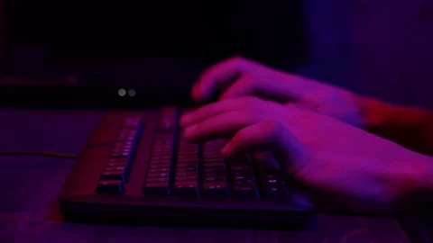 Working on the keyboard. Close-up. Blue-red illumination Stock Footage 124360781