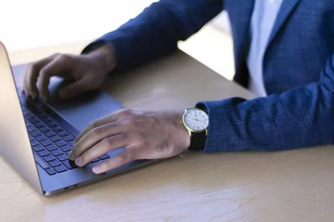 Working on keyboard laptop computer successful businessman in a jacket sitting Stock Photos