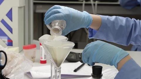 Working in a laboratory to study the quality of a liquid product in test tub Stock Footage 340144004