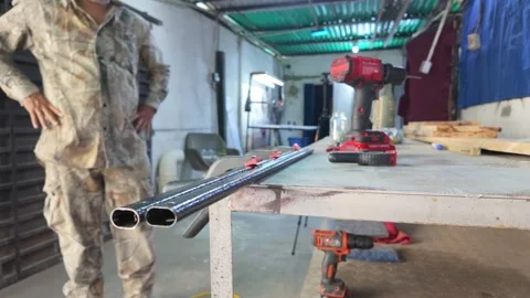 Working labour. Man arranging tools on workshop workbench. Stock Footage 312202154