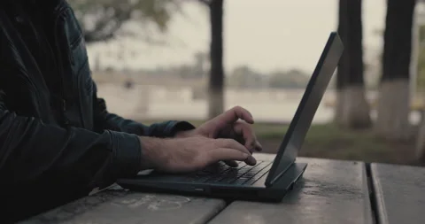 Working at lap top in city park Stock Footage 168374440