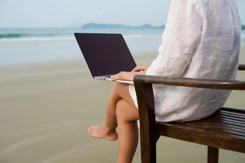 Working with laptop at beach Stock Photos