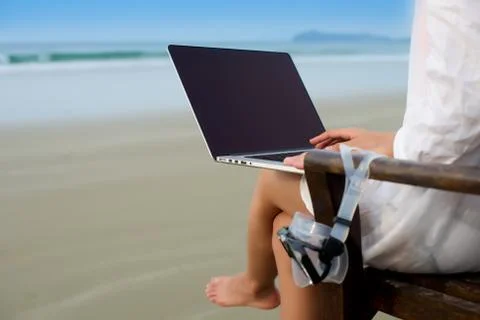 Working with laptop at beach Stock Photos