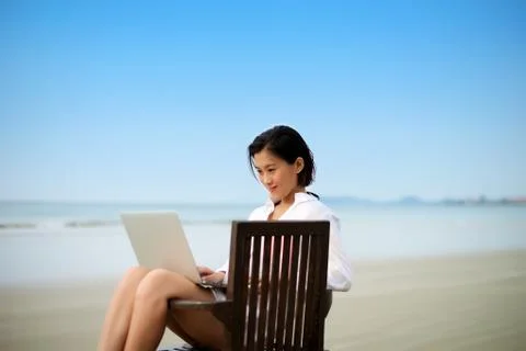 Working with laptop at beach Stock Photos