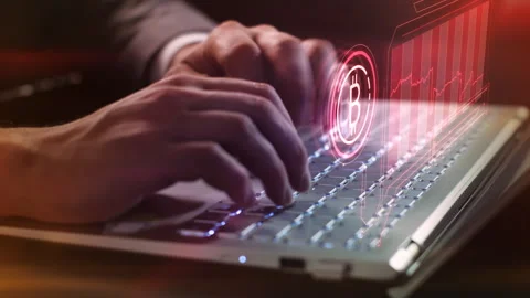 Working on a laptop with bitcoin decline infographics. Stock Footage 256928201