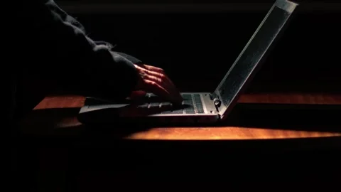 Working on laptop in dark room medium Stock Footage 259217064