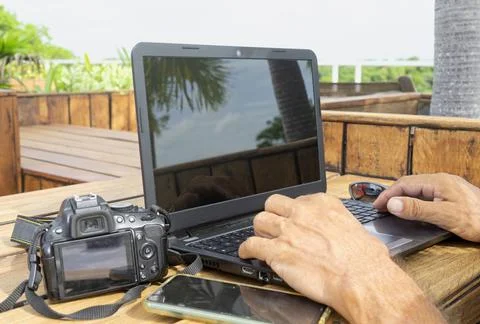Working with a laptop on the garden table Fotos de archivo