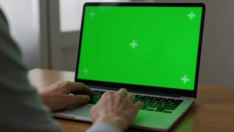 Working on Laptop with Green Screen Display 4K Side view of a person typing.. Video stock 312076678