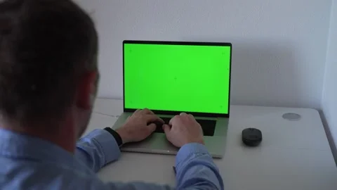 Working on a laptop with green screen display in a home office setting in t.. Stock Footage 340189905