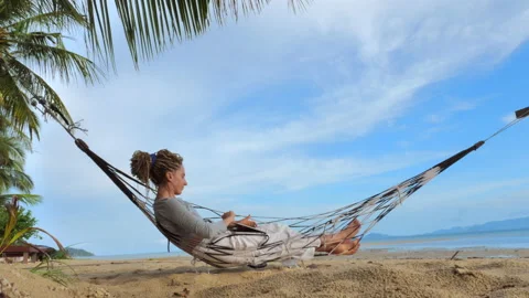 Working on Laptop lying in Hammock Stock Footage 172035878