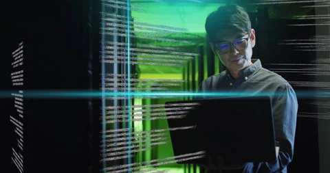 Working on laptop, man in server room with coding animation over green light Stock Footage 306507744