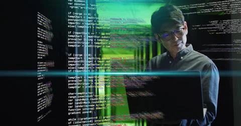 Working on laptop, man in server room with coding image over green light Foto stock