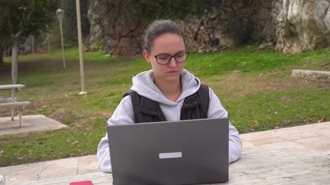 Working on a laptop. Outside. Stock Footage 169927136