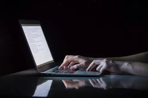 Working at laptop pc at night.  Stock Photos