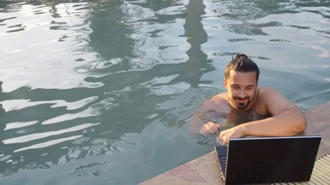 Working on laptop from the swimming pool Stock Footage 72260374