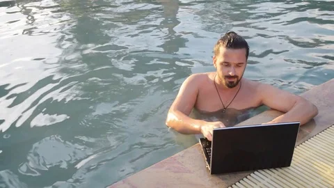 Working on laptop from the swimming pool Stock Footage 72260419