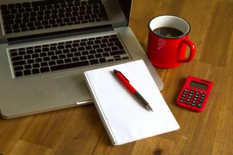 Working with the laptop, taking some notes and drinking a cup of coffee Stock Photos