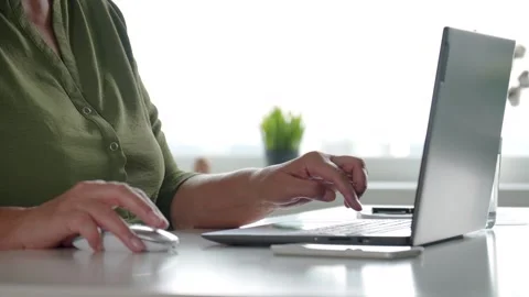Working on laptop typing on keyboard in office Stock Footage 315896905