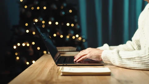 Working on laptop while sitting at home with Christmas decorations Stock Footage 220724388