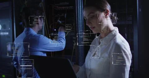 Working on laptop, woman with code snippets over data center background Stock Photos