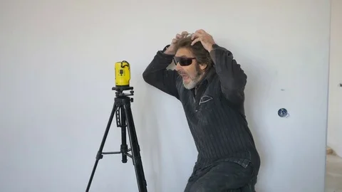 Working with a laser level makes markings on the wall. Mechanical lifting Stock-Footage 74764396