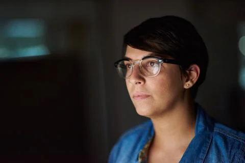 Working late to complete her assignment. Cropped shot of a young woman working Stock Photos