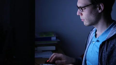 Working late night on computer or browsing internet, freelance job Stock Footage 98093632