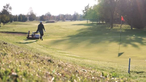 Working Lawnmower Cuts Grass On The Golf Field At Sunrise in Italy Stock Footage 123371598