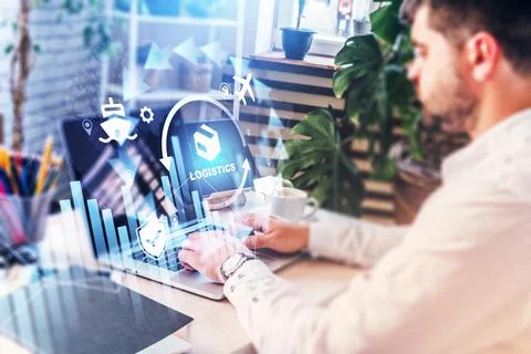 Working on logistics software with data visualization on a laptop at a desk Stock Photos