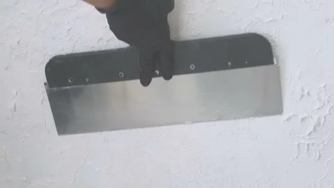 Working long trowel plastering wall white putty Stock Footage 135470068