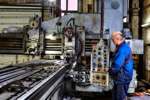 Working machine operator controls the processing of metal Stock Photos