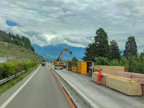 Working machinery and workers doing road repairs Stock Photos
