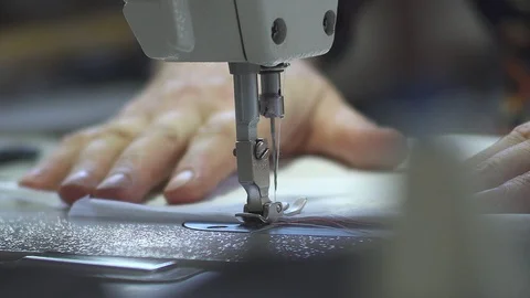 Working macro detail of the sewing machine. the needle moves and sews the fabric Stock Footage 94917434